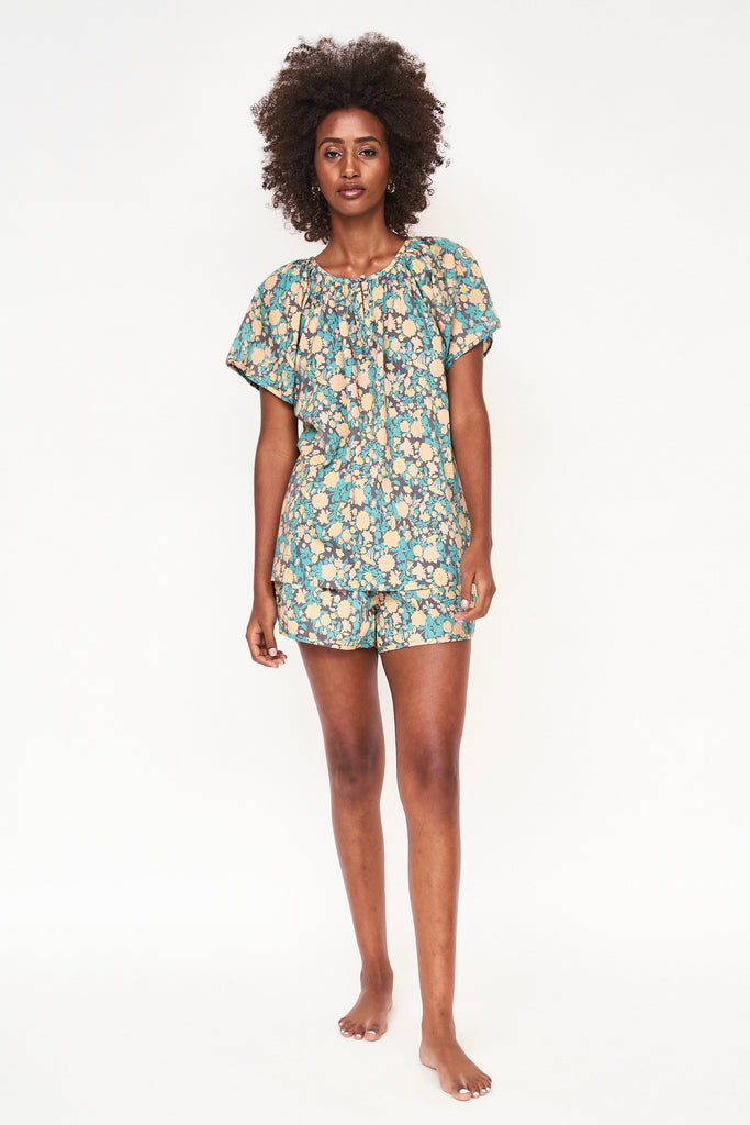 Girl wearing MIRTH women's short sleeve pajama short set in onyx bloom floral cotton