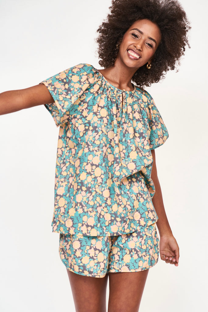 Girl wearing MIRTH women's short sleeve pajama short set in onyx bloom floral cotton