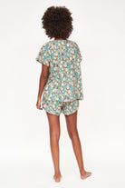 Girl wearing MIRTH women's short sleeve pajama short set in onyx bloom floral cotton