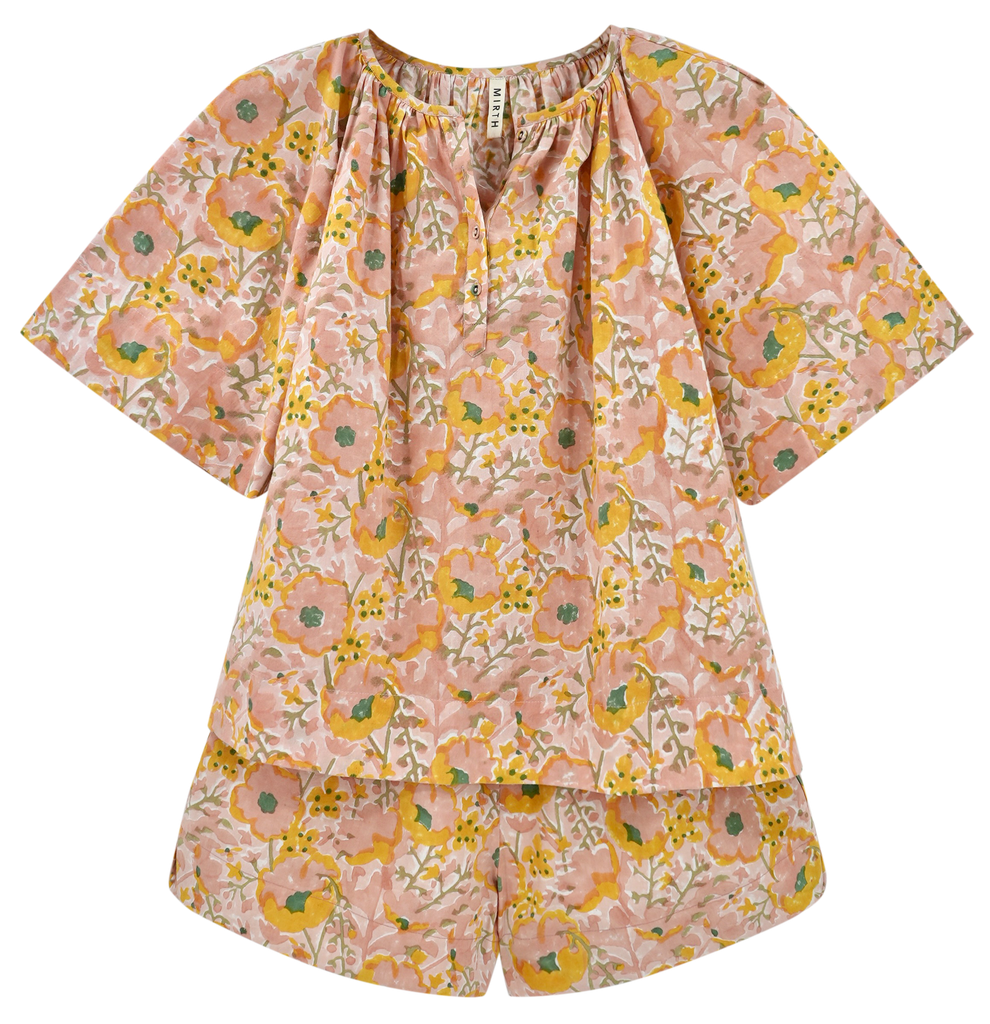 Girl wearing MIRTH women's short sleeve pajama short set in pink lemonade cotton
