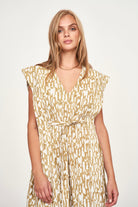 Girl wearing MIRTH women's v neck layered pintuck sleeveless long belted laguna dress in driftwood brown print cotton