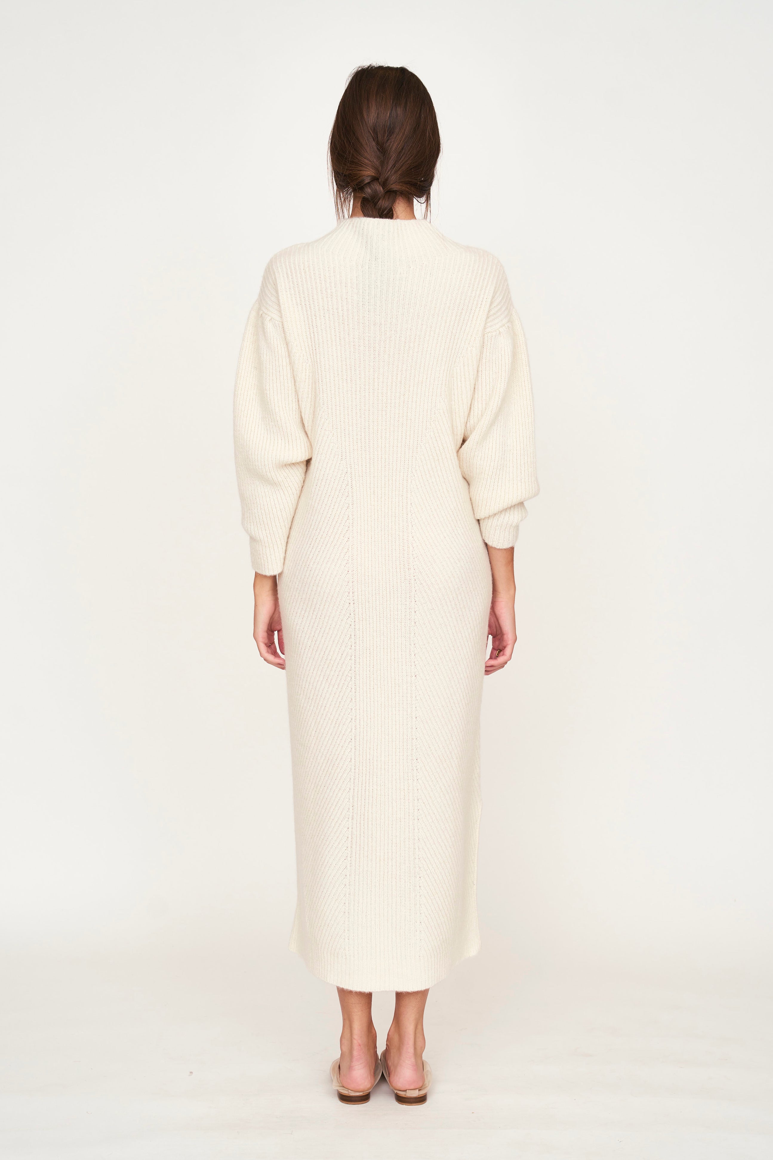 Girl wearing MIRTH women's knit pichu pichu sweater dress in ivory white wool