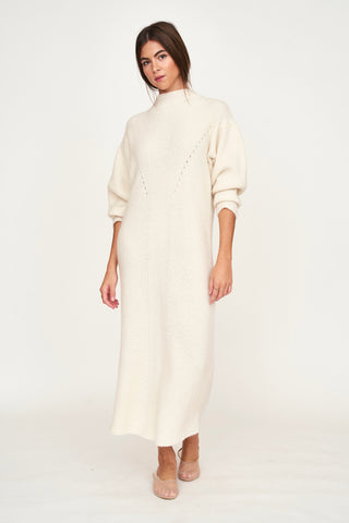 Girl wearing MIRTH women's knit pichu pichu sweater dress in ivory white wool