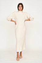 Girl wearing MIRTH women's knit pichu pichu sweater dress in ivory white wool