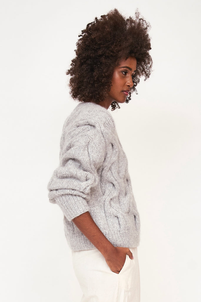 Girl wearing MIRTH women's handknit cortina cable pullover sweater in dove grey wool