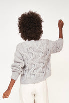 Girl wearing MIRTH women's handknit cortina cable pullover sweater in dove grey wool