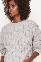 Girl wearing MIRTH women's handknit cortina cable pullover sweater in dove grey wool