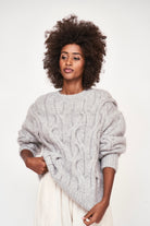 Girl wearing MIRTH women's handknit cortina cable pullover sweater in dove grey wool