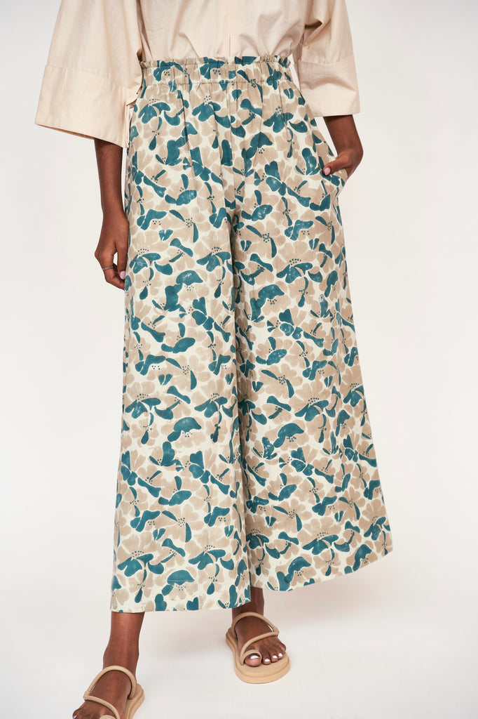 Girl wearing MIRTH women's paperbag waist wide leg palazzo pant in plumeria blue floral cotton