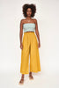 Girl wearing MIRTH women's paperbag waist wide leg palazzo pant in gilded yellow cotton
