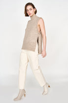 Girl wearing MIRTH women's knit aspen high neck open side vest in camel brown wool