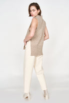 Girl wearing MIRTH women's knit aspen high neck open side vest in camel brown wool