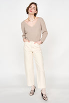 Girl wearing MIRTH women's knit v neck bellagio sweater in taupe brown wool