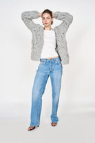 Girl wearing MIRTH women's handknit cortina cable cardigan sweater in dove grey wool