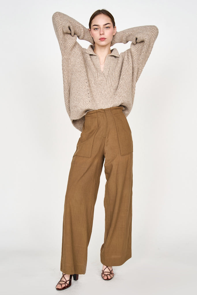 Girl wearing MIRTH women's v neck pullover sweater in camel brown wool