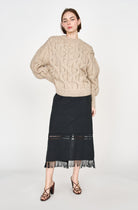 Girl wearing MIRTH women's midi fringe cutout lombok skirt in black cotton