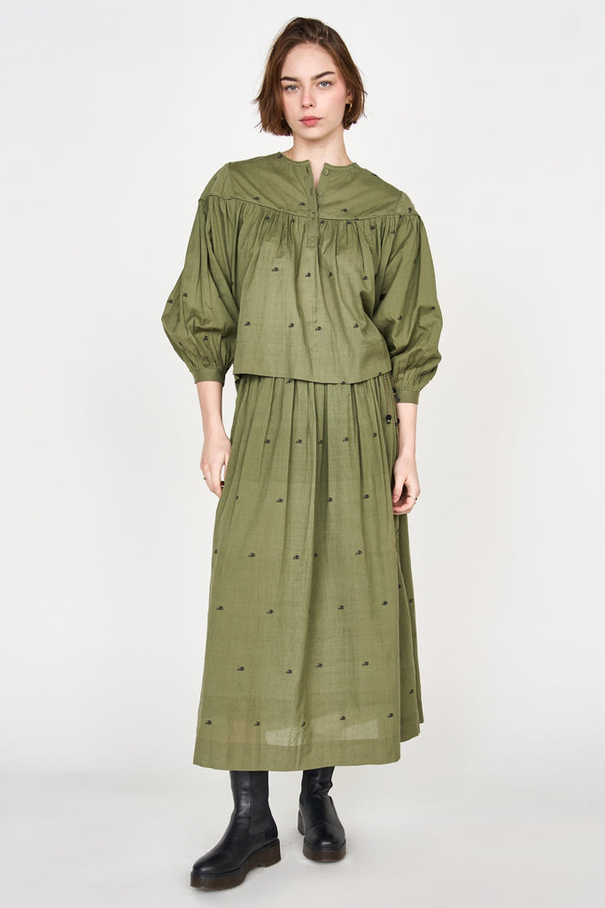 Girl wearing MIRTH women's puff sleeve pullover oslo blouse in handloomed jamadani olive green cotton