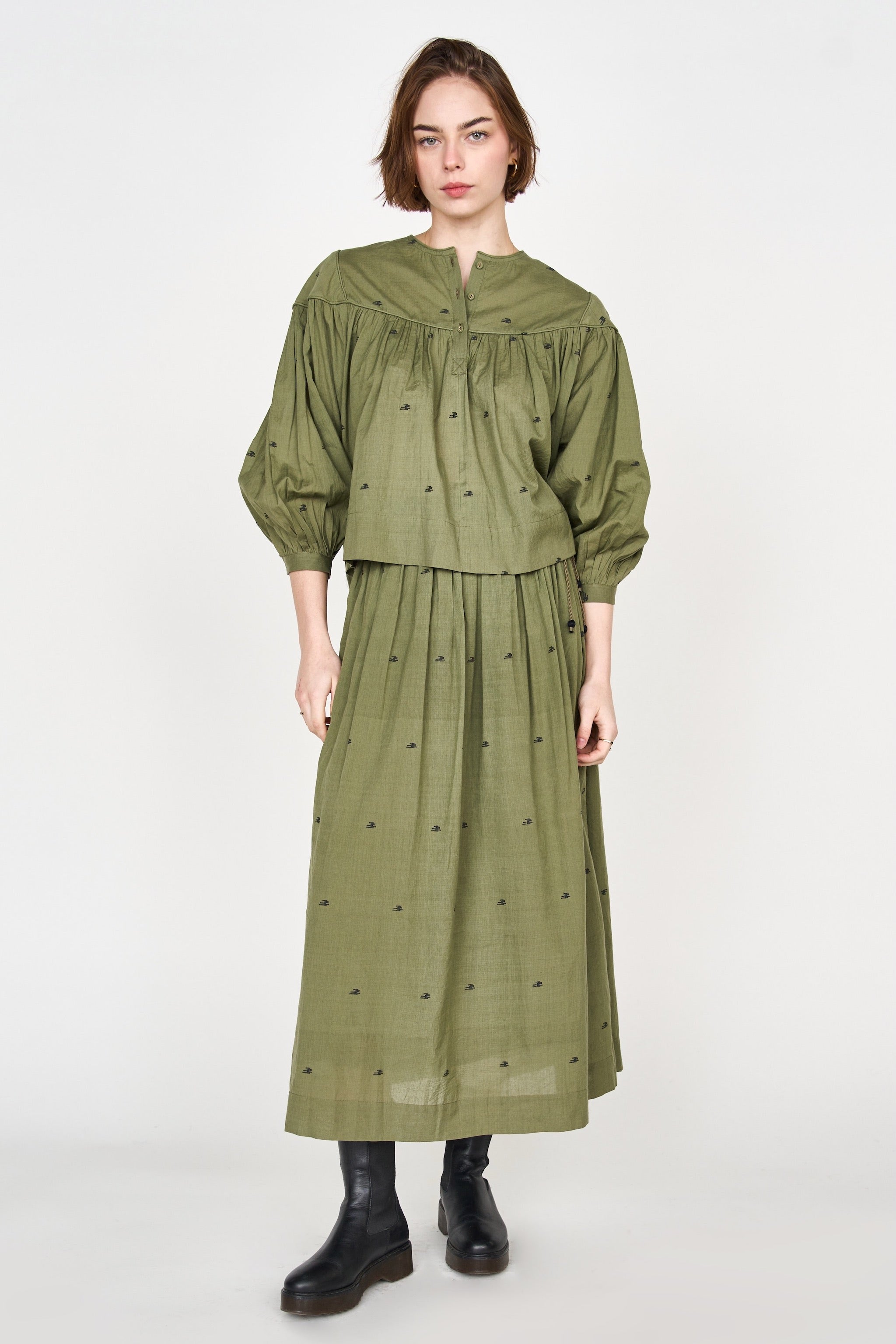 Girl wearing MIRTH women's lowy maxi verona vacation skirt in handloomed jamdani olive green cotton