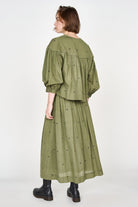 Girl wearing MIRTH women's lowy maxi verona vacation skirt in handloomed jamdani olive green cotton