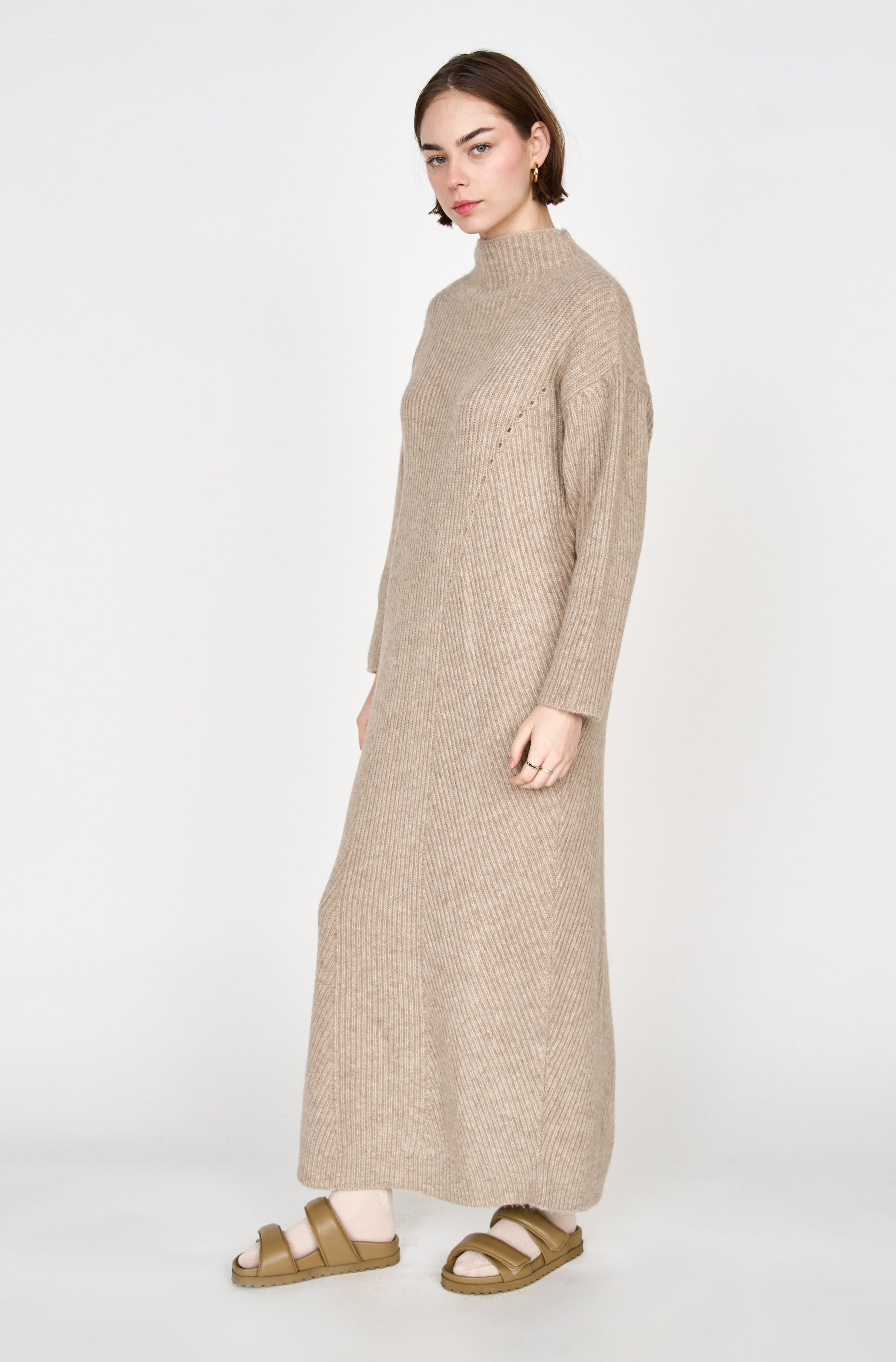 Girl wearing MIRTH women's knit pichu pichu sweater dress in camel brown wool