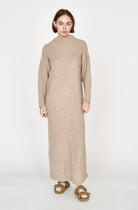 Girl wearing MIRTH women's knit pichu pichu sweater dress in camel brown wool