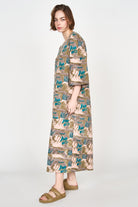 Girl wearing MIRTH women's square neck long caftan dress in brown moss reef blockprint