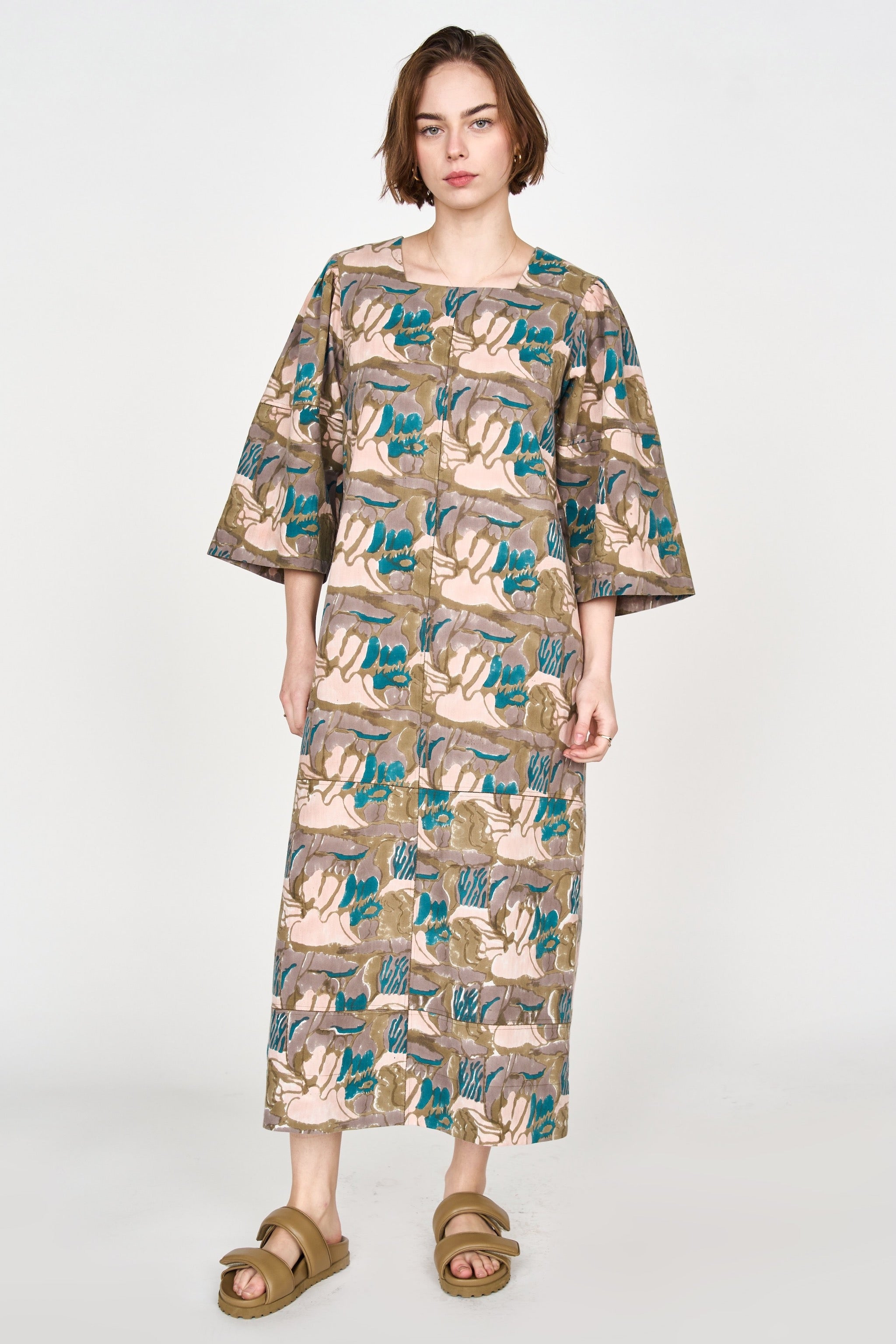 Girl wearing MIRTH women's square neck long caftan dress in brown moss reef blockprint