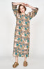 Girl wearing MIRTH women's square neck long caftan dress in brown moss reef blockprint