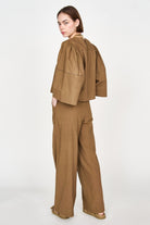 Girl wearing MIRTH women's high waist tivot pant in tannin brown cotton