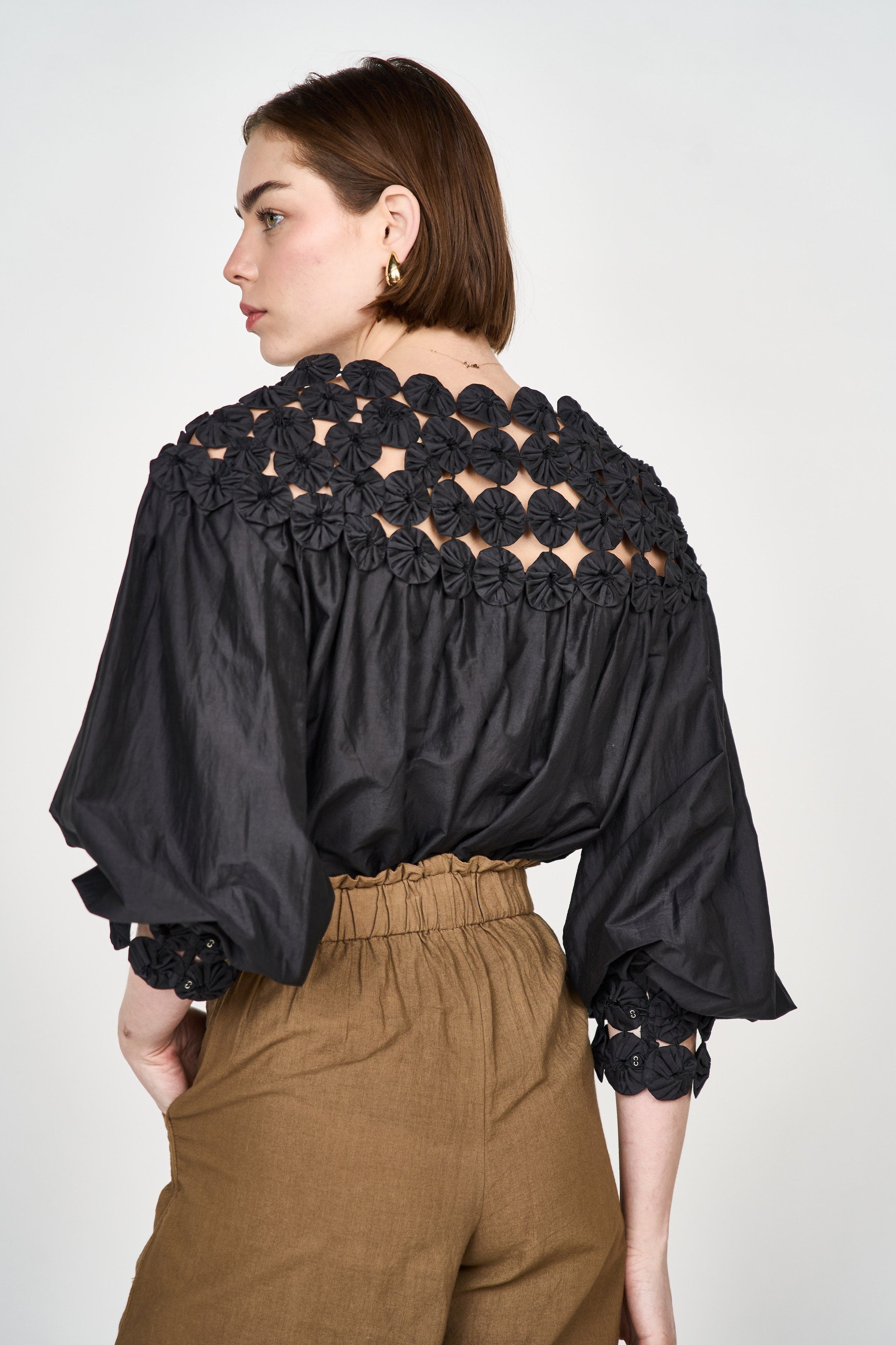 Girl wearing MIRTH women's pullover rosette rosenberg blouse in black cotton silk