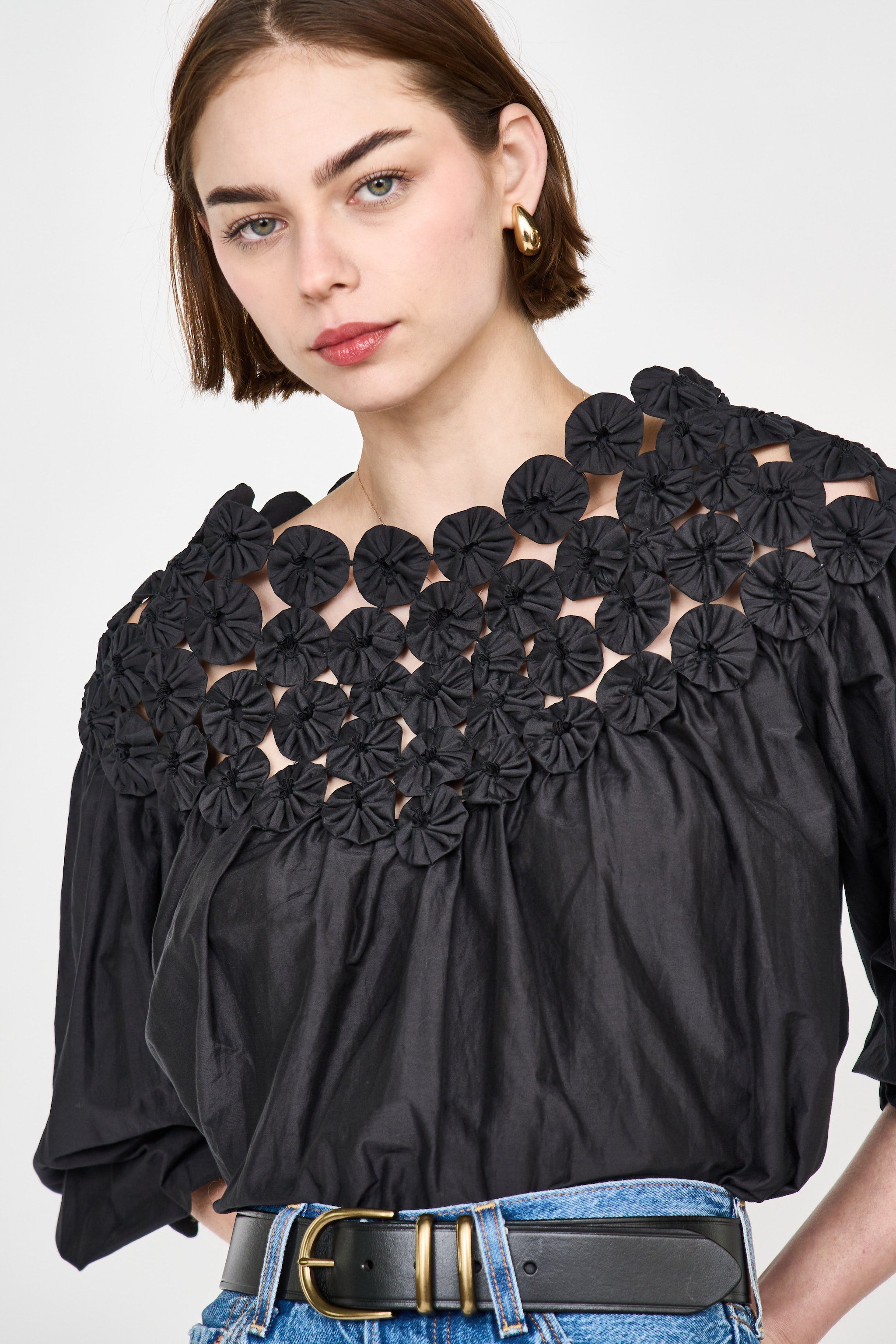 Girl wearing MIRTH women's pullover rosette rosenberg blouse in black cotton silk