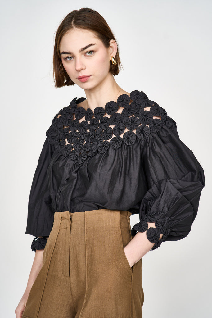 Girl wearing MIRTH women's pullover rosette rosenberg blouse in black cotton silk