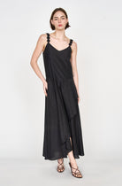 Girl wearing MIRTH women's long singapore spaghetti strap drop waist dress in black cotton silk