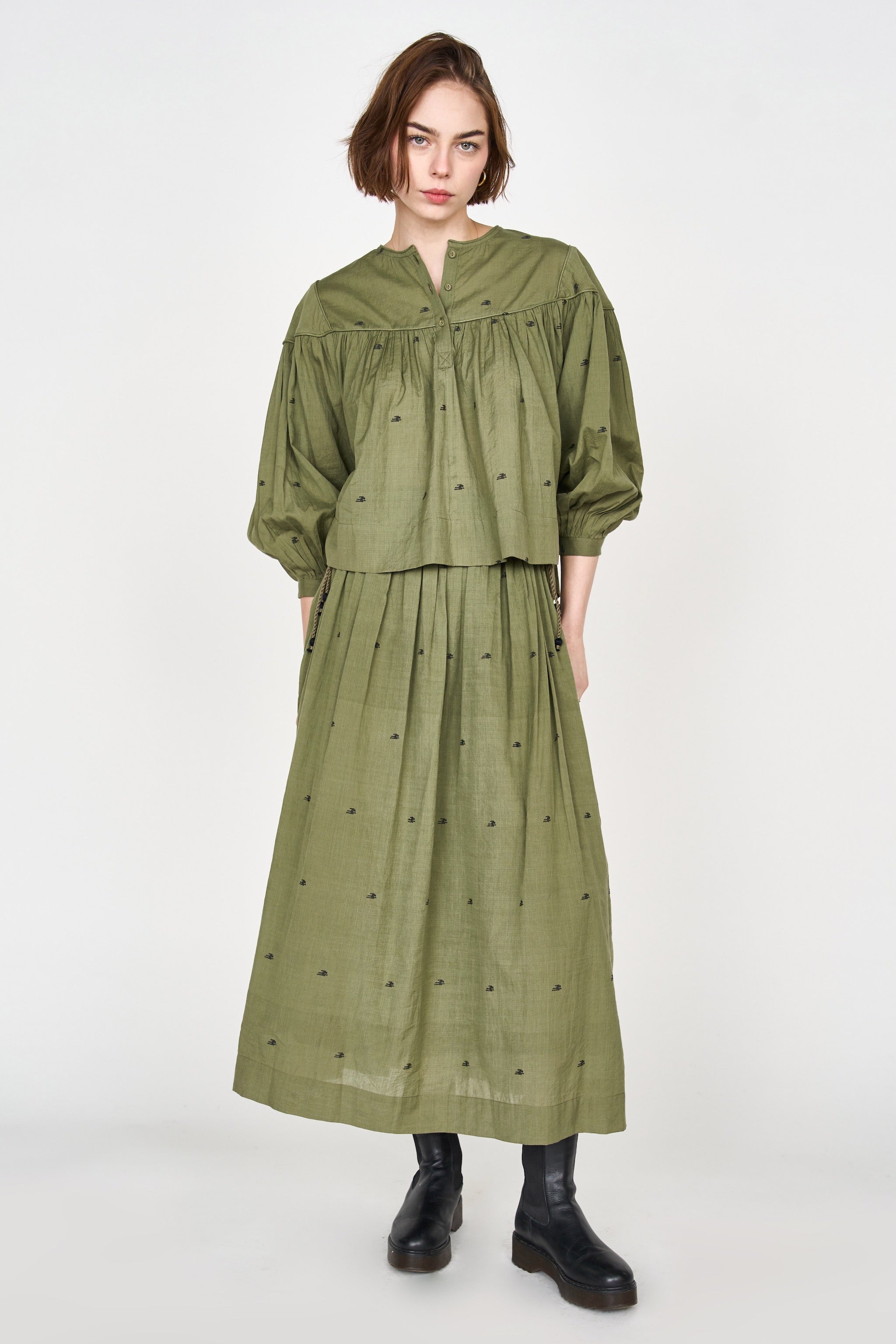 Girl wearing MIRTH women's lowy maxi verona vacation skirt in handloomed jamdani olive green cotton