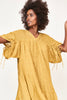 Girl wearing MIRTH women's v neck pleated pull string malta lined coverup short dress in gilded yellow cotton