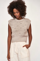 Girl wearing MIRTH women's hand crocheted marin sweater vest in koala grey alpaca wool