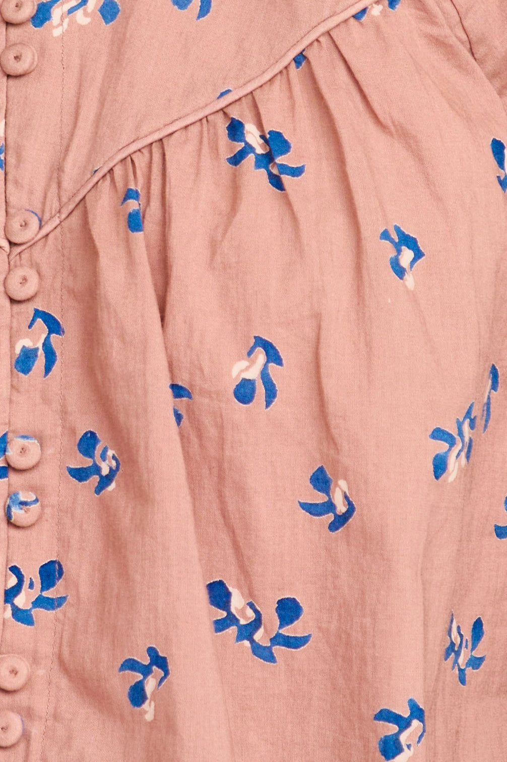 Close-up of a pink garment with blue floral patterns