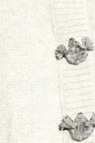 Two small, textured objects on a textured white background