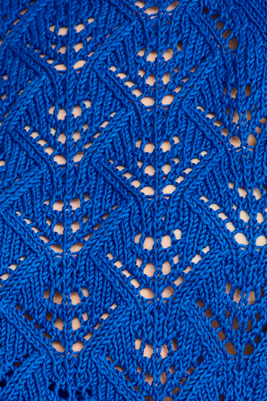 Close-up of blue knitted fabric with a geometric pattern