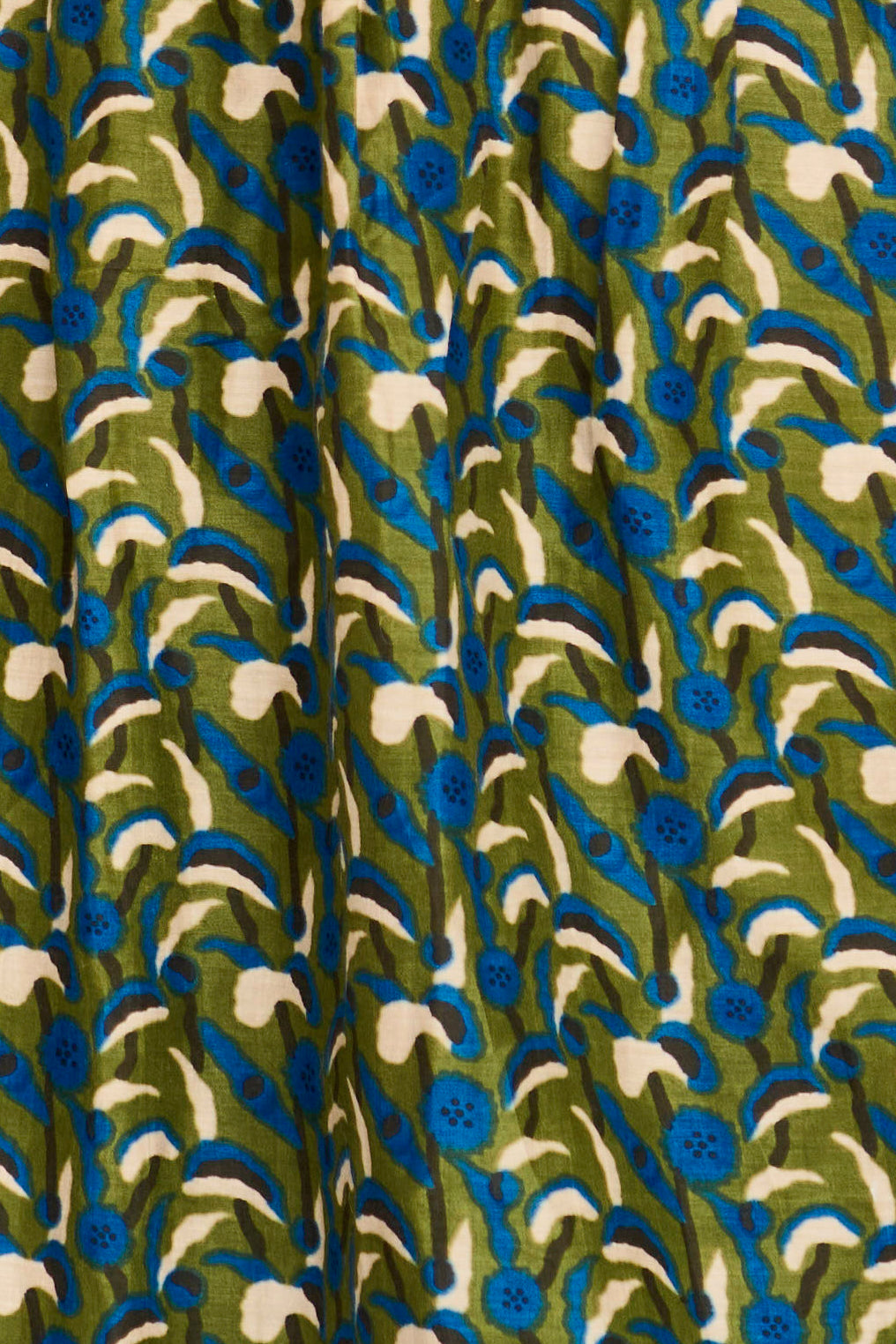Patterned fabric with blue, green, and white design on a brown background
