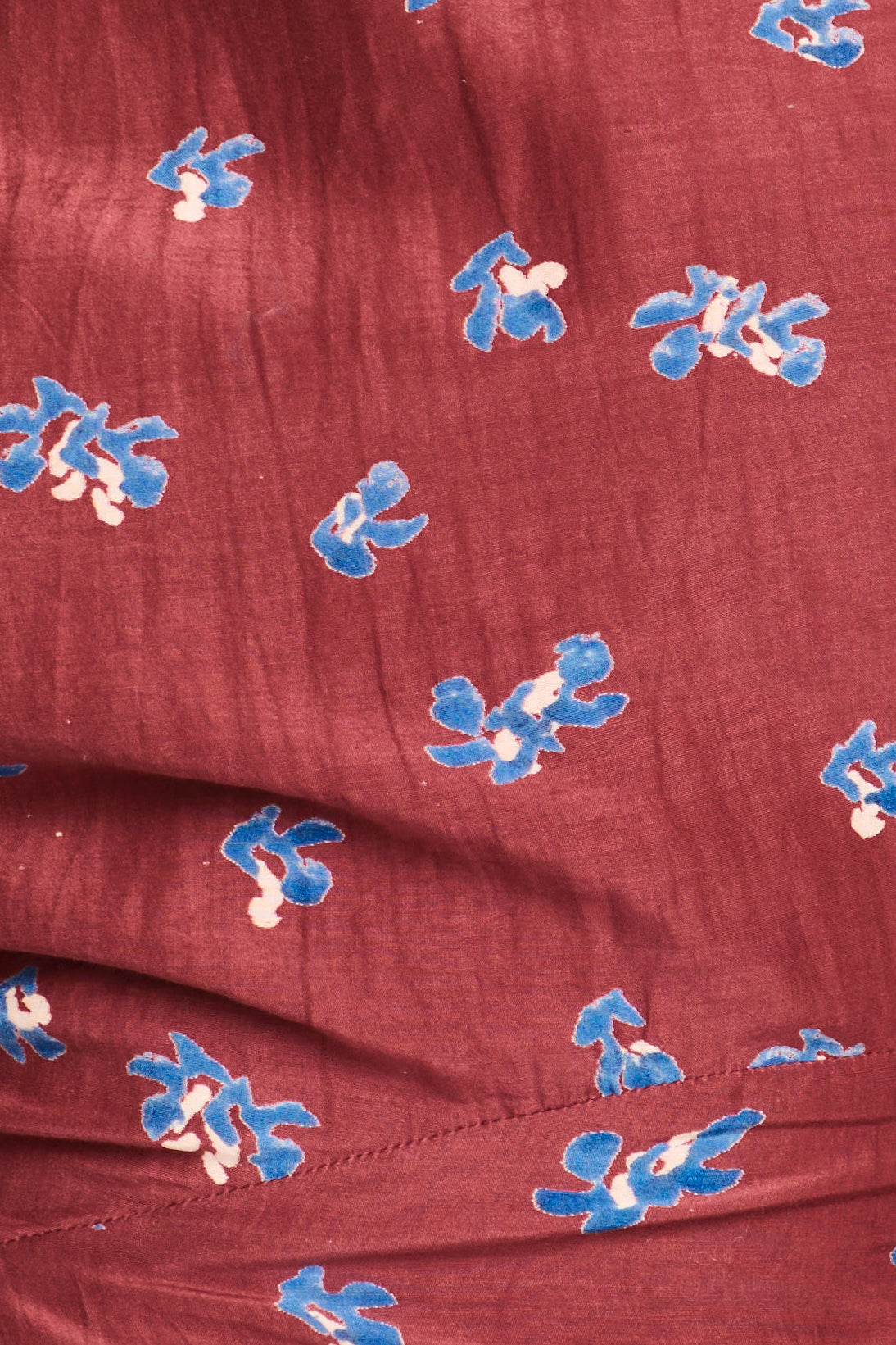 Red fabric with blue floral patterns