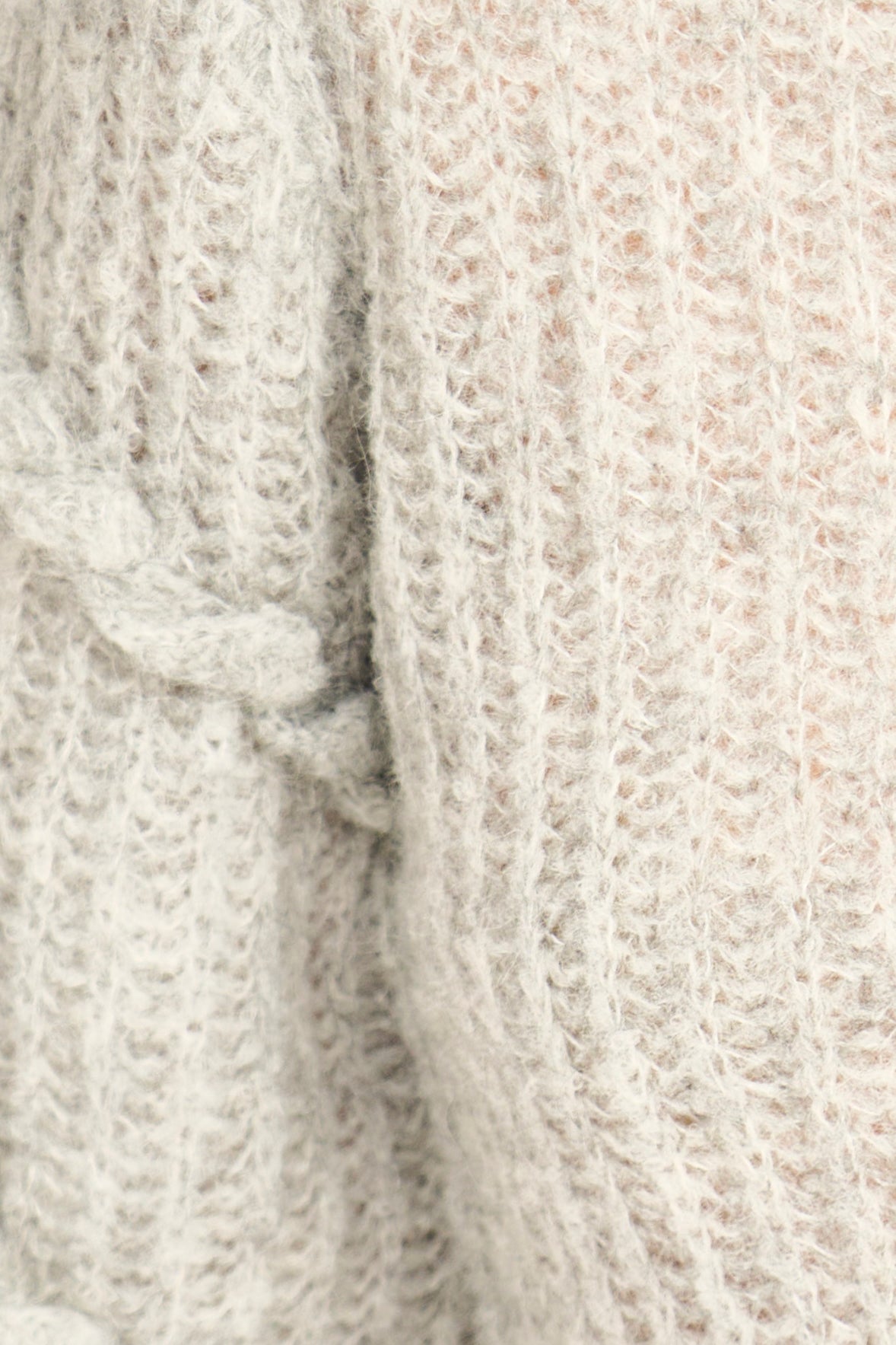 Close-up of textured beige fabric with a subtle pattern