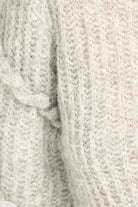 Close-up of textured beige fabric with a subtle pattern
