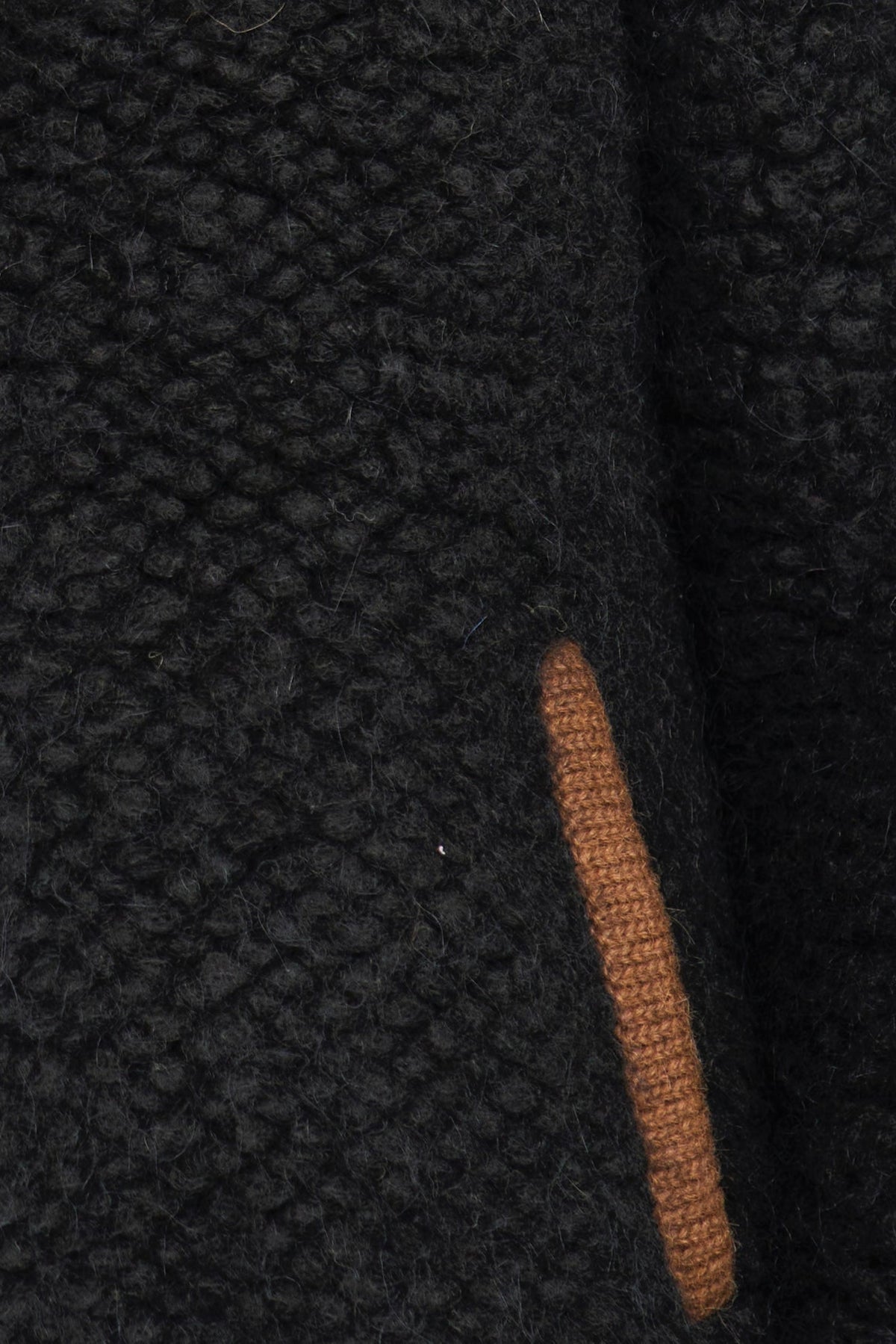 Close-up of a textured black fabric with a brown stripe