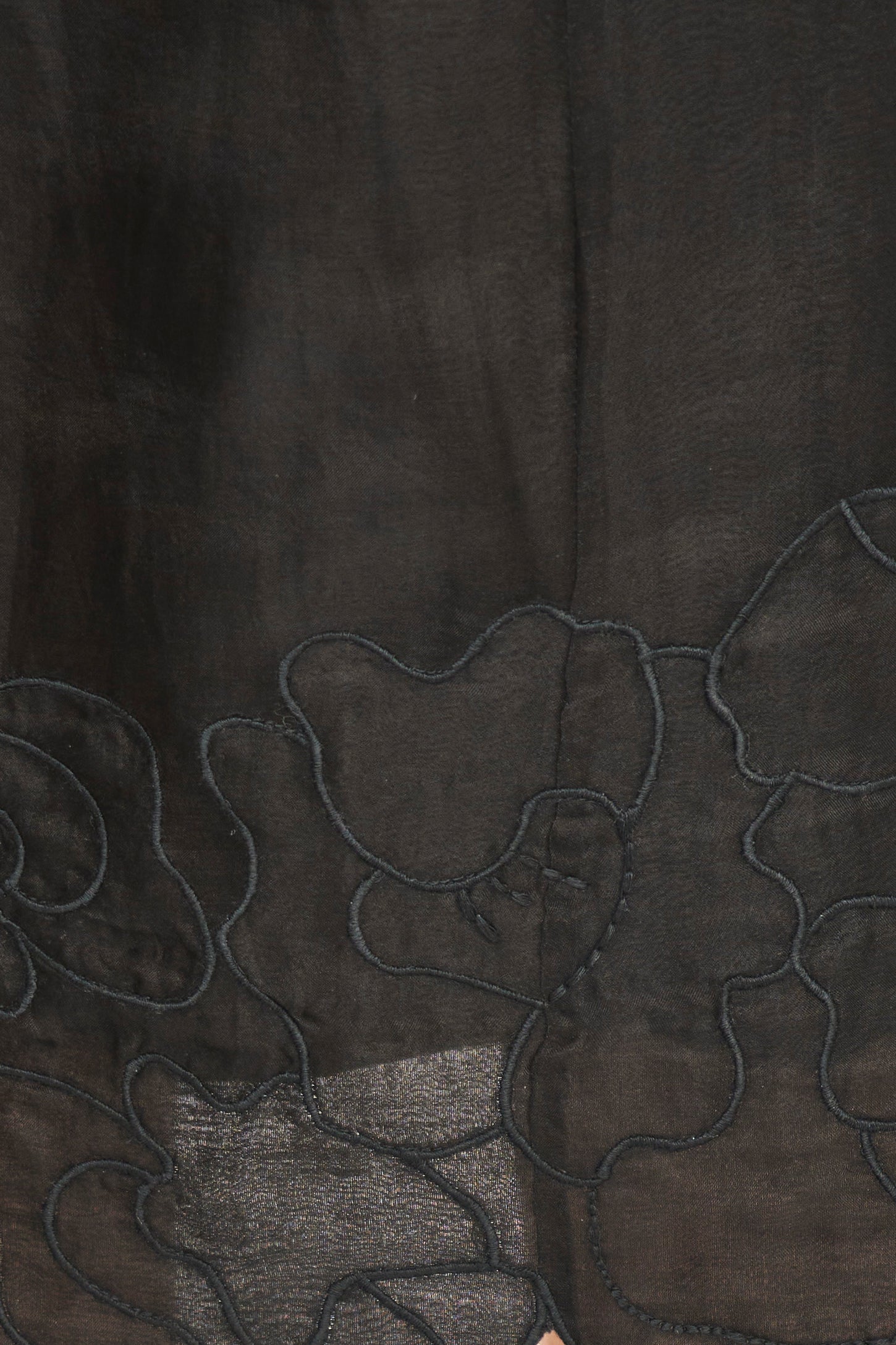 Close-up of dark fabric with floral embroidery