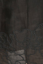 Close-up of dark fabric with floral embroidery