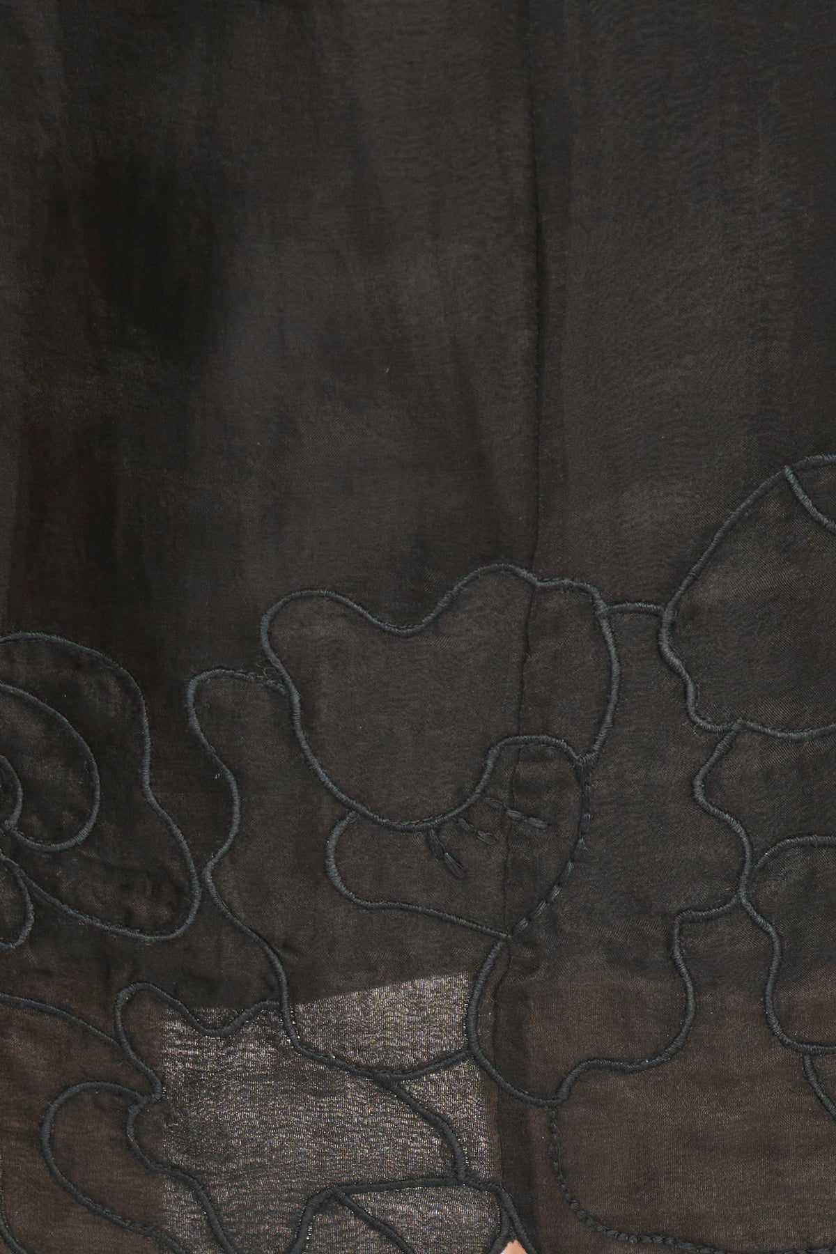 Close-up of dark fabric with floral embroidery