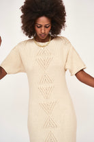 Girl wearing MIRTH women's knit short sleeve long resort sweater dress osaka in bone cream