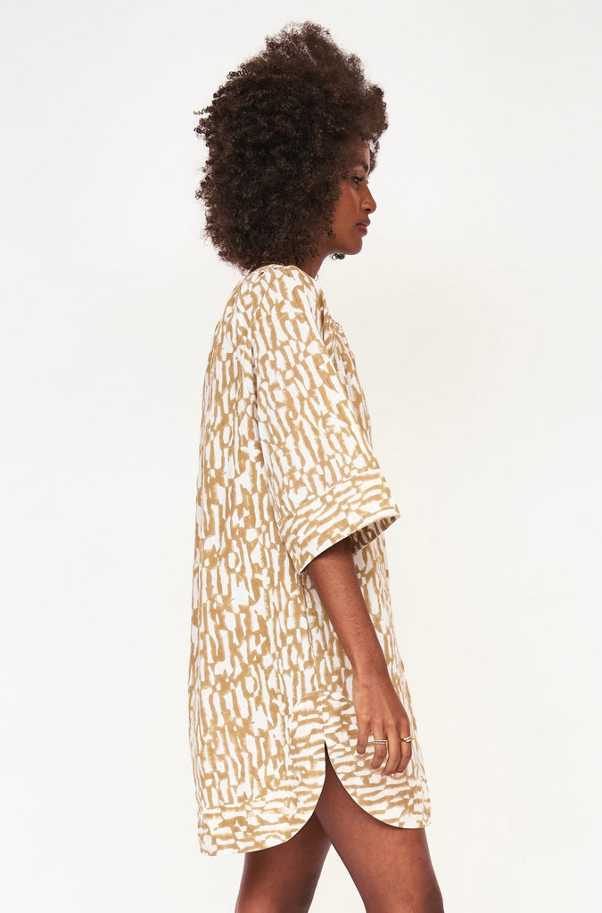 Girl wearing MIRTH women's v neck short sleeve palm springs short dress in driftwood brown print cotton