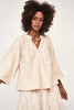 Girl wearing MIRTH women's v neck ruched collar three quarter sleeve palm springs top in parchment beige cotton poplin
